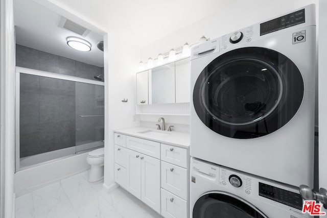 laundry area featuring sink and stacked washer and clothes dryer