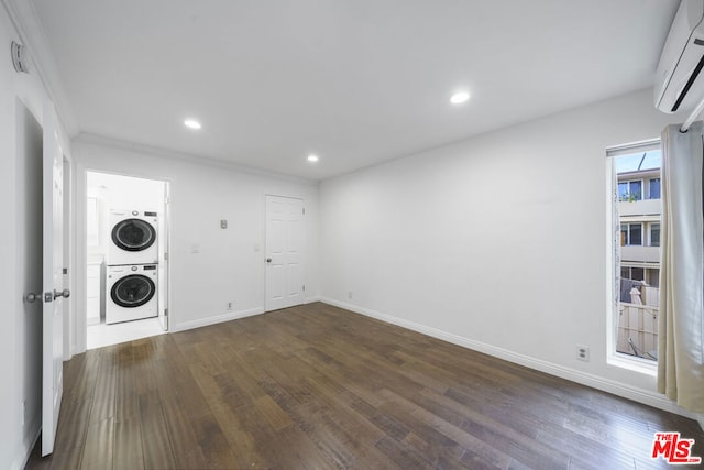 washroom featuring stacked washer and dryer, dark wood-type flooring, ornamental molding, and an AC wall unit