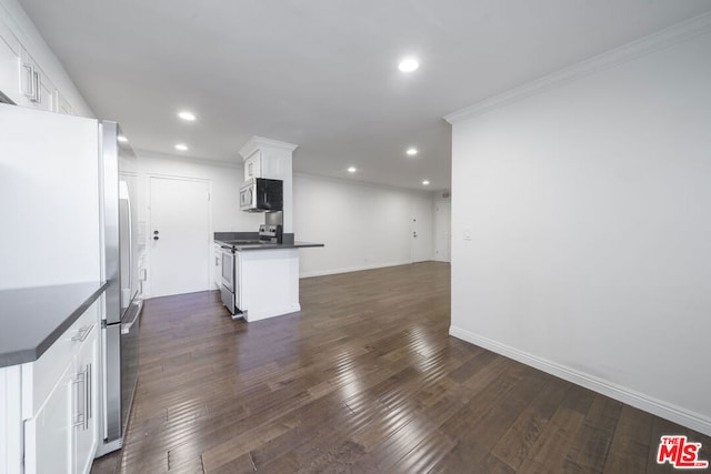 kitchen with dark hardwood / wood-style floors, stainless steel appliances, crown molding, and white cabinetry