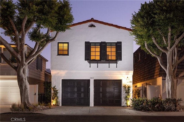 mediterranean / spanish home with a garage