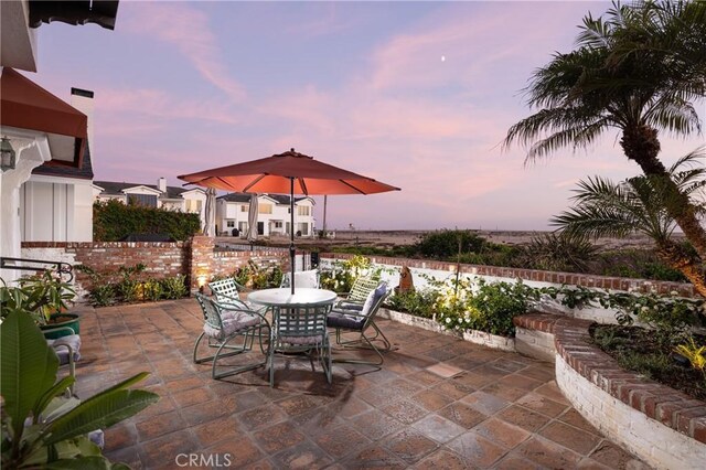 view of patio terrace at dusk