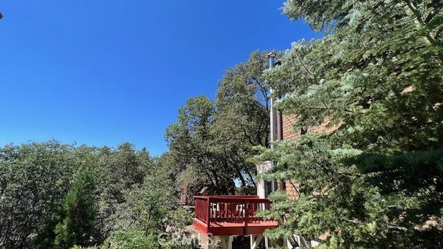 view of property exterior featuring a wooden deck