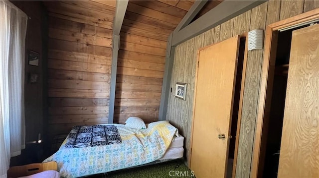 bedroom with vaulted ceiling and wooden walls