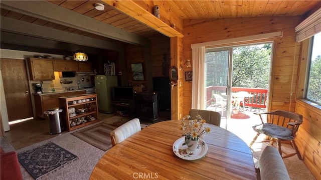 dining space with vaulted ceiling, wood ceiling, and wooden walls