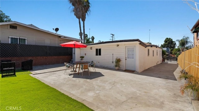 back of house featuring a yard and a patio