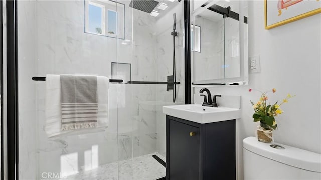 bathroom with a shower with door, toilet, and vanity