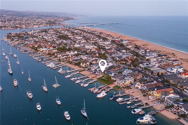 birds eye view of property with a beach view and a water view