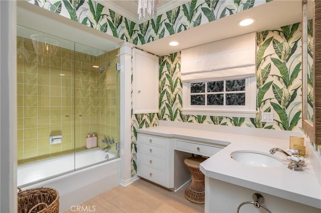 bathroom featuring shower / bath combination with glass door, vanity, ornamental molding, and a chandelier