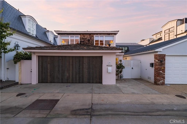 view of garage at dusk