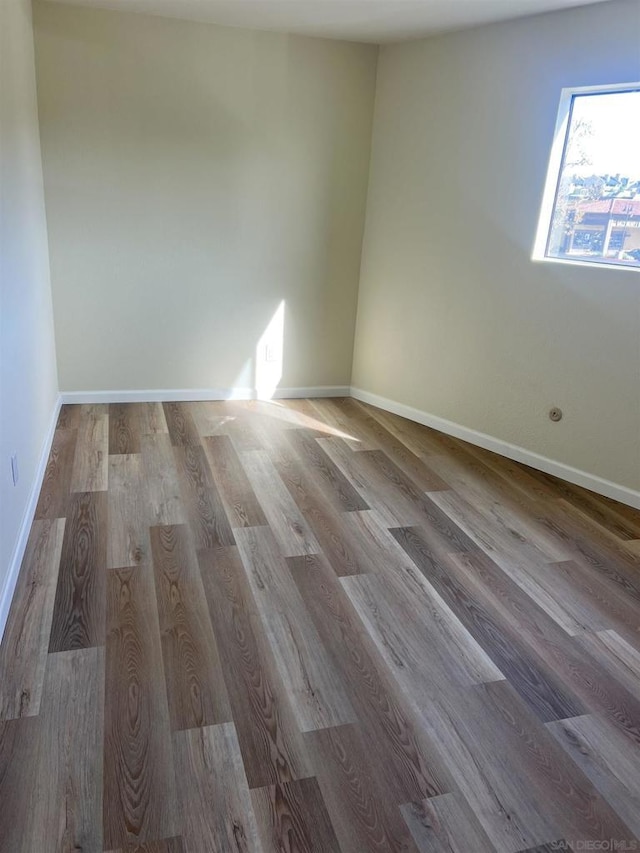 spare room featuring wood-type flooring