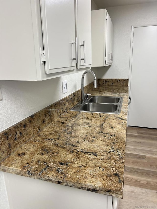 kitchen with white cabinetry and sink