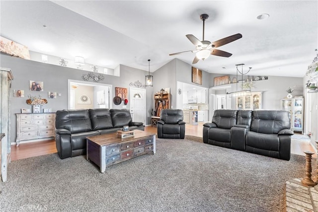 carpeted living room with ceiling fan and lofted ceiling