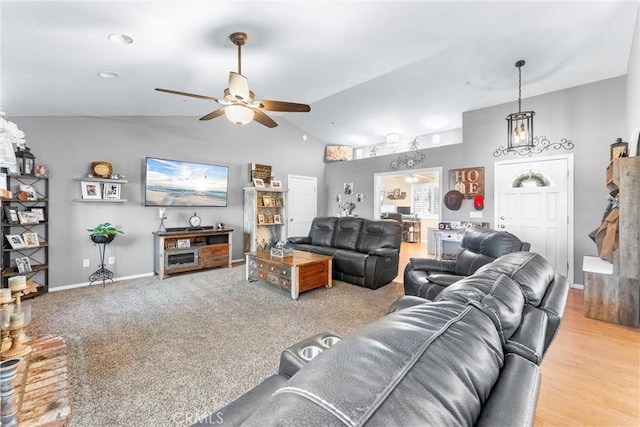 living room featuring ceiling fan and vaulted ceiling