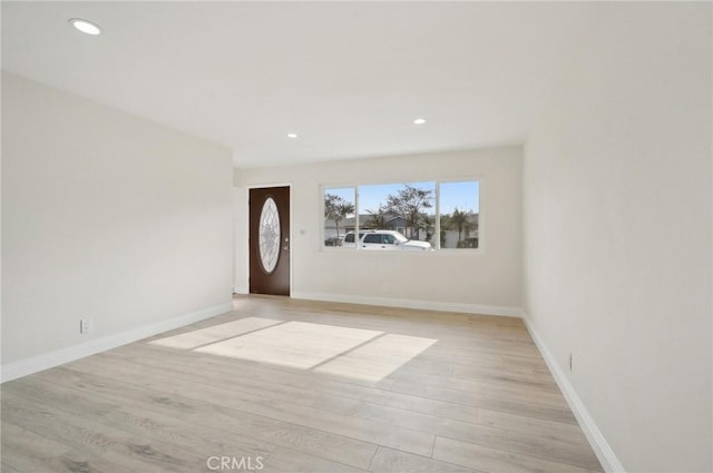 foyer entrance with light hardwood / wood-style floors