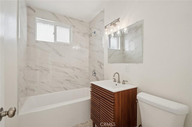 full bathroom with toilet, tiled shower / bath combo, and vanity