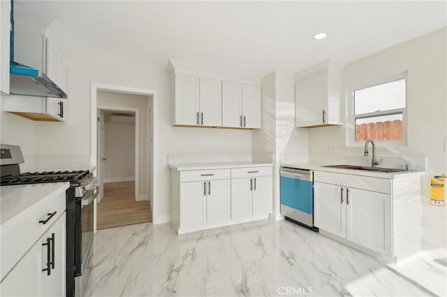 kitchen with white cabinets, appliances with stainless steel finishes, and sink