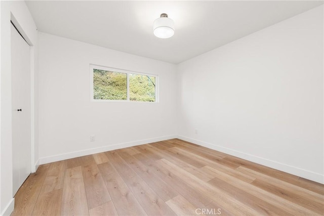 spare room featuring wood-type flooring