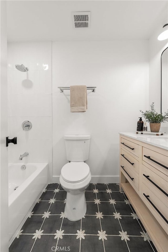 full bathroom with toilet, vanity, tile patterned flooring, and tiled shower / bath