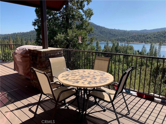 deck with a grill and a water view