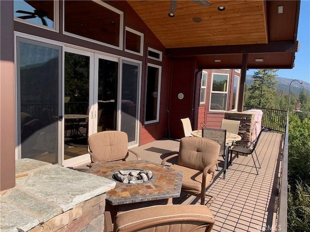 view of patio with ceiling fan and an outdoor fire pit