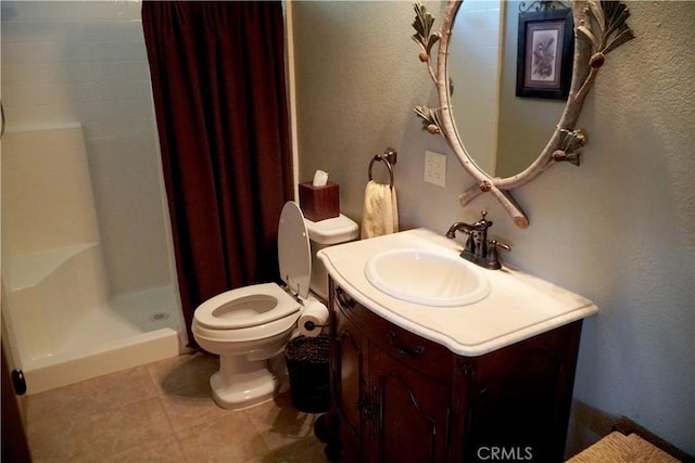 bathroom with toilet, walk in shower, and vanity