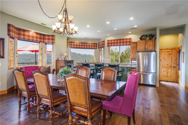 dining area featuring dark hardwood / wood-style floors and a chandelier