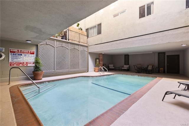 view of swimming pool featuring a patio