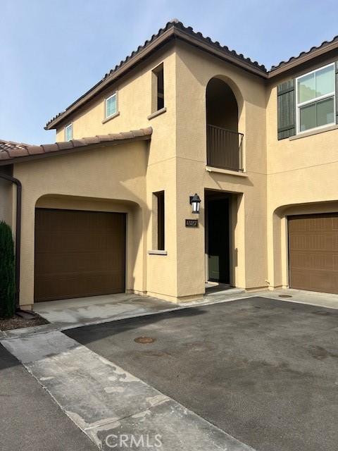 mediterranean / spanish-style house with a garage