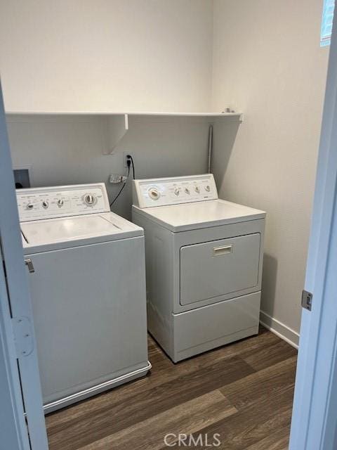 washroom with washer and clothes dryer and dark hardwood / wood-style flooring