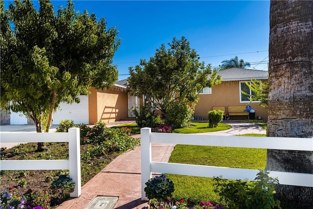 view of front of property featuring a garage and a front yard