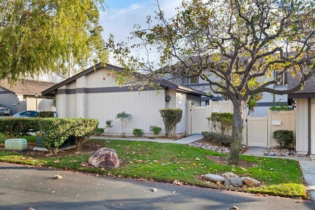 view of side of home with a yard