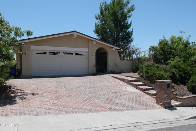 ranch-style home featuring a garage