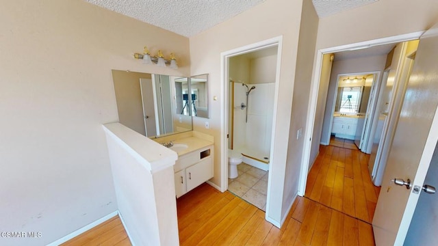 bathroom with a shower, wood-type flooring, toilet, and vanity