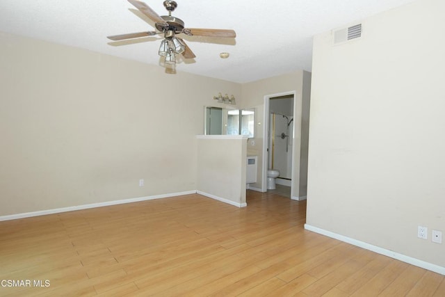 spare room with ceiling fan and light wood-type flooring