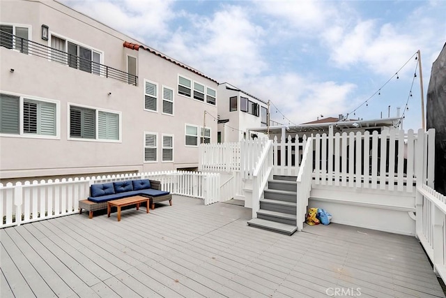 wooden deck with an outdoor living space