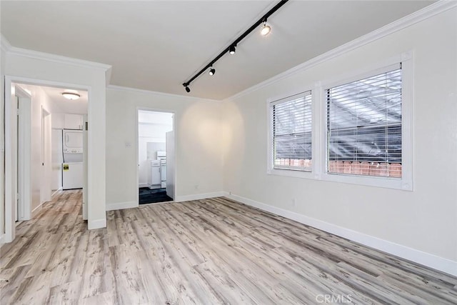 interior space featuring rail lighting, light hardwood / wood-style flooring, and ornamental molding