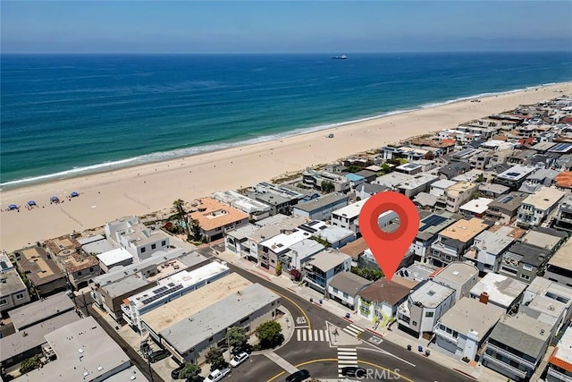 aerial view with a water view and a view of the beach