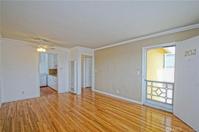 empty room featuring ceiling fan, light wood-type flooring, and ornamental molding