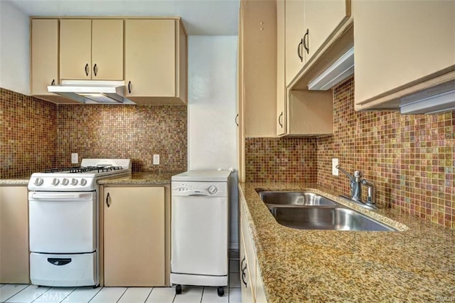 kitchen with decorative backsplash, sink, white appliances, and light tile patterned flooring