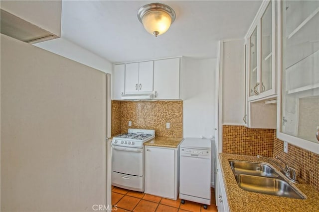 kitchen with tasteful backsplash, sink, white appliances, and white cabinetry