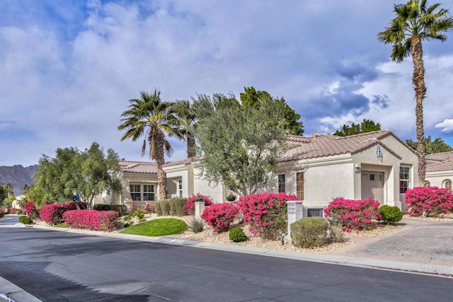 mediterranean / spanish-style home featuring a garage