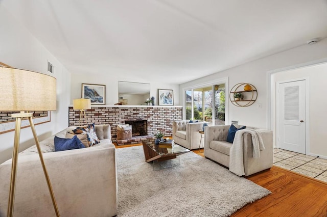 living room with a fireplace and wood-type flooring