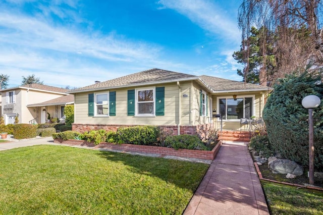 view of front of home with a porch and a front lawn