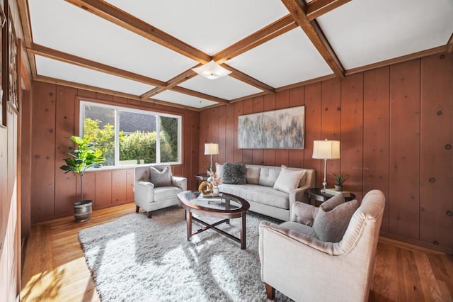 living room featuring beam ceiling, light wood-type flooring, and coffered ceiling