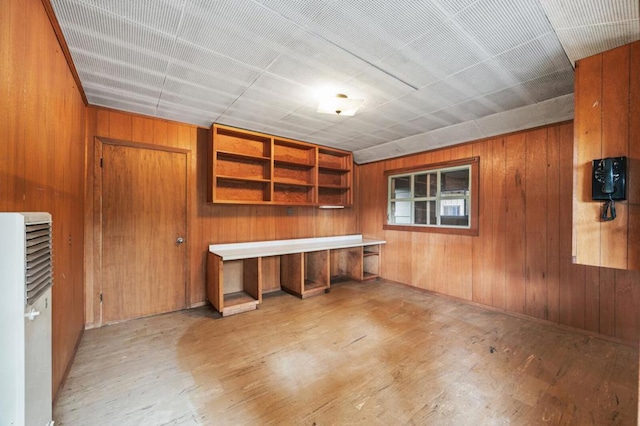 interior space featuring light hardwood / wood-style floors and wooden walls