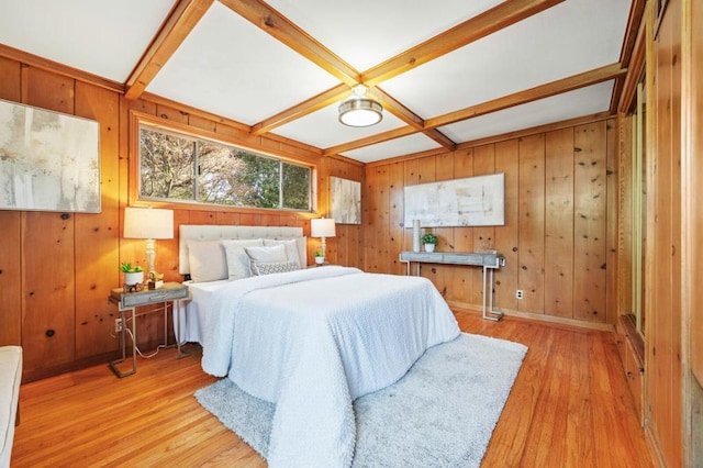 bedroom with beam ceiling, light wood-type flooring, and coffered ceiling