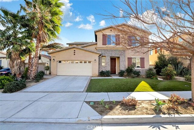 mediterranean / spanish-style house featuring a garage and a front lawn