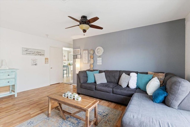 living room featuring hardwood / wood-style flooring and ceiling fan