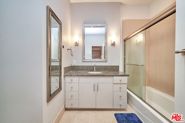 bathroom with bath / shower combo with glass door and vanity