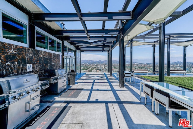 view of patio / terrace featuring a mountain view, a grill, and a pergola